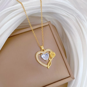 Luxury gold heart pendant necklace with shimmering crystals and small rose detail