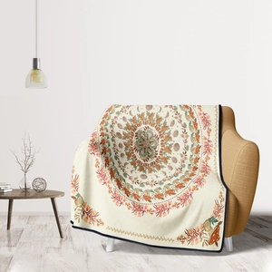 Detail of bohemian mandala flannel blanket with mushroom and moon phase motifs on sofa