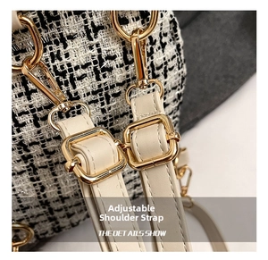 Detail of adjustable tweed and leather shoulder strap with gold-tone metal buckles