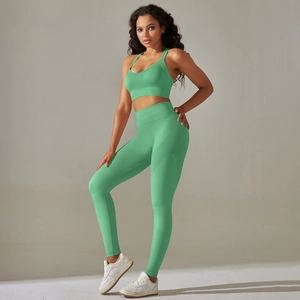 Detail of mint green seamless yoga set featuring cross-back sports bra and high-waisted leggings