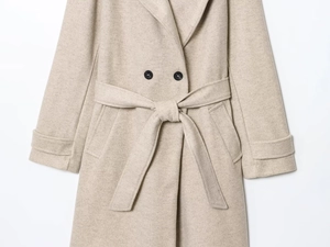 Detail of oatmeal wool coat featuring black double-breasted buttons and belted waistline