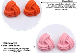 Detail of matte geometric twisted earrings featuring orange and pink epoxy lacquer finish