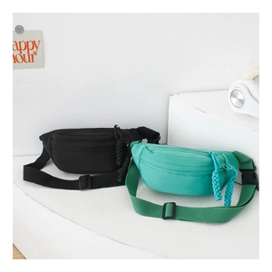 Detail of adjustable straps and zipper pulls on black and blue nylon kids fanny packs