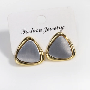 Minimalist gold and silver contrast triangle stud earrings with a brushed metal finish