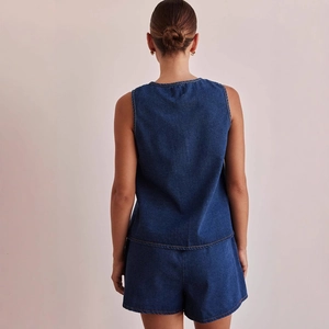 Women sleeveless denim two-piece set with back view on minimalist beige background