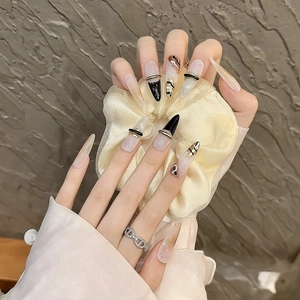 Handmade stiletto press-on nails with golden brown marbling and 3D cross relief