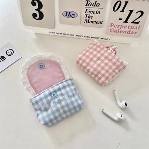 Close-up of quilted heart pattern cotton headphone cases with sweet white lace edges
