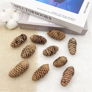 Macro detail of natural dried pine cones on rustic burlap and soft white fur background