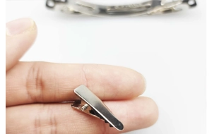 Macro shot showing the 2cm mini silver metal alligator hair clip size on a finger