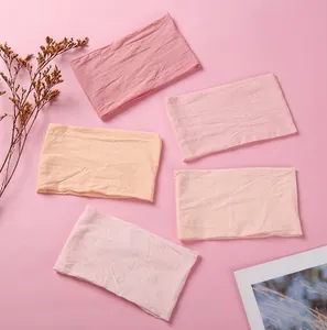 Detail of five-piece knotted nylon headband set in gradient pink and peach tones