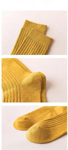Macro detail of ginger yellow ribbed knit socks showing high-quality fiber texture