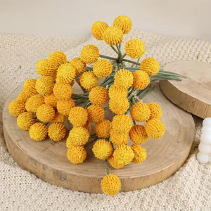 Artificial yellow craspedia bouquet on wood slice for Nordic minimalist home decor