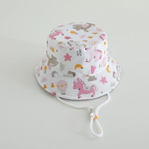 Detail of white kids bucket hat featuring unicorn rainbow prints and adjustable chin strap