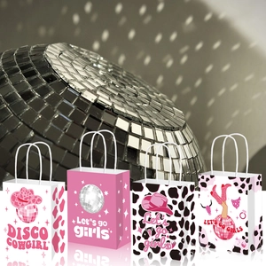 Detail of Disco Cowgirl party gift bags with cow print and glitter ball motifs
