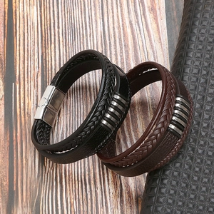 Detail of multi-layer braided leather bracelets with silver magnetic clasps