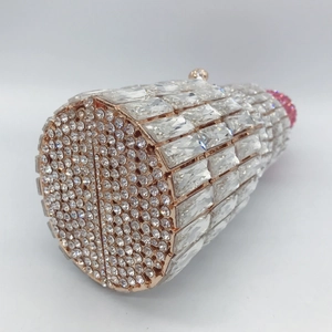 Macro shot showing detailed layered crystal inlays on the silver lipstick clutch bag