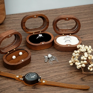 Detail of walnut wood jewelry box with magnetic closure and clear glass window