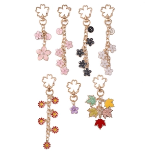Floral daisy cherry blossom metal keychains in multiple colors with initial charms