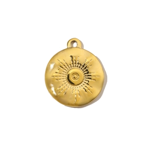 Detail of a golden round sunburst pendant with embossed eye pattern for DIY jewelry