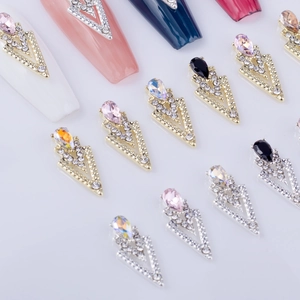 Arrowhead alloy nail art gems with pear-shaped rhinestones in gold and silver bases