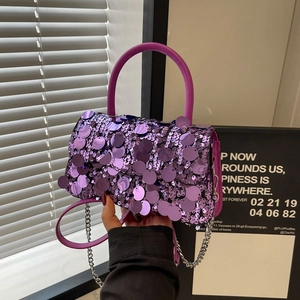 Detail of purple sequin crossbody bag with silver metal chain strap and curved handle