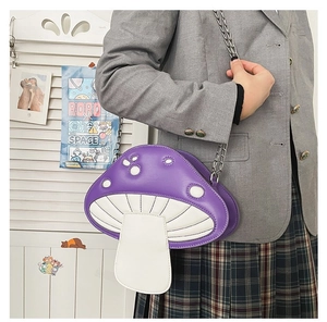 Detailed view of a purple mushroom crossbody bag with white dots and metal chain strap