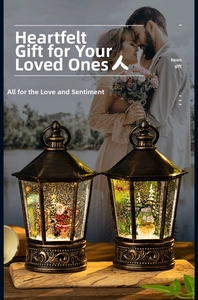 Close-up of vintage bronze Christmas lantern with LED snow globe scene and warm lights