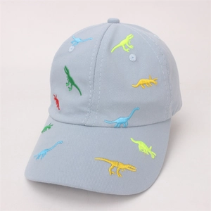 Macro detail of colorful dinosaur embroidery on a light blue cotton baseball cap for kids
