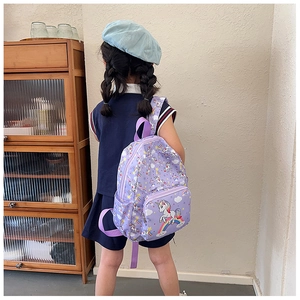 Detailed back view of purple canvas kids backpack with unicorn and rainbow prints