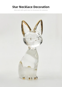 Detail of glass Egyptian cat storm bottle with gold accents and star necklace decor