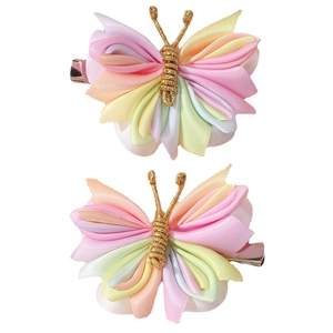 Pair of colorful fabric butterfly hair clips with macaron tones and metal alligator base