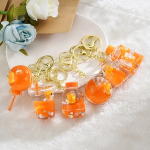 Orange acrylic liquid quicksand keychains with cartoon duck and floating glitter charms