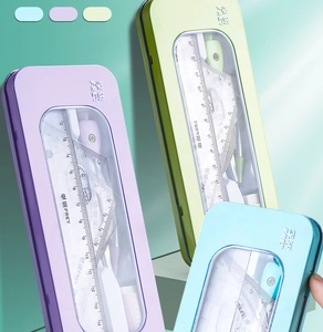 Detailed view of math geometry sets in purple, green, and blue metal storage cases