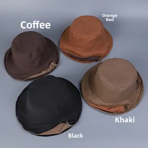 Detailed flat lay of linen bucket hats in coffee, orange, black, and khaki colors