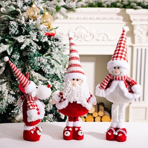 Close-up of Santa, Reindeer, and Snowman plush figurines with festive knit patterns