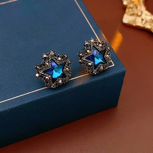 Nahaufnahme der Vintage Blaue Stern Ohrringe mit Kristallen auf einer Schmuckbox