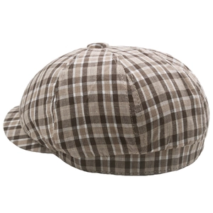 Close-up of retro plaid cotton newsboy cap with classic brown and beige checkered texture