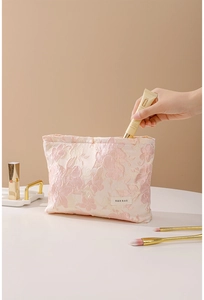 Pink embossed floral makeup bag showing large storage capacity for skincare products