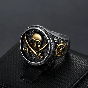 Mens vintage pirate skull ring with cross swords and gold helm on black textured stand