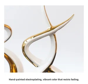 Detail of manual electroplating on modern ceramic sculpture with vibrant gold finish