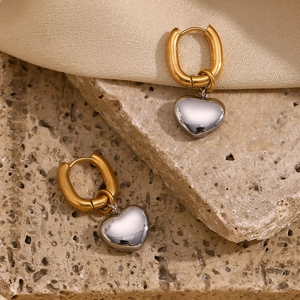 Detail of 18K gold-plated horseshoe hoop with a silver-tone heart pendant on stone