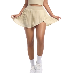 Detail view of beige pleated tennis skirt featuring a high waist and athletic fabric