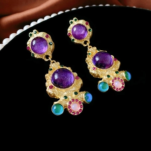 Vintage gold baroque earrings featuring a large purple gemstone and colorful crystal accents