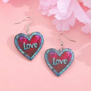 Close-up of heart-shaped acrylic earrings with Love print and blue-purple gradient texture