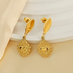 Elegant gold-tone stainless steel heart earrings with vintage texture on white satin