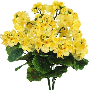 Detailed view of yellow artificial geranium flowers with vibrant green leaves on white background