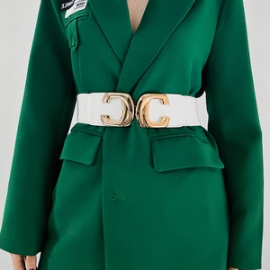 Close-up of white leather wide belt with a golden geometric C-shaped metal buckle