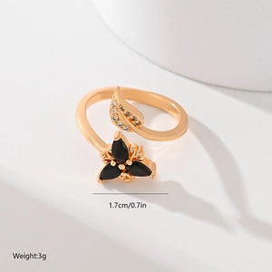 Detailed view of leaf design gold ring featuring black stones and 1.7cm adjustable opening