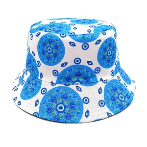Detail of white bucket hat with blue mandala and evil eye pattern print