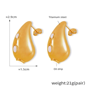 Detail view of gold PVD plated titanium steel teardrop earrings with oil drip finish